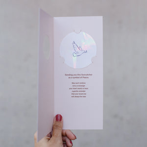 Inside: "Sending you this Suncatcher as a symbol of Peace. May each rainbow carry a message your heart needs to hear; a gentle reminder that your loved one with always be near." The Suncatcher sticker has a line drawing of a flying dove.